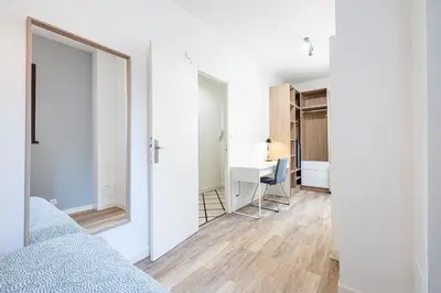 a room with a bed and a desk and a mirror at Chambre privée 1 personne BAIL MOBILITE in Nice