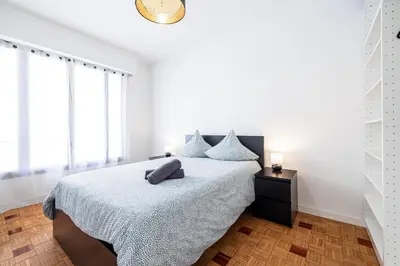 a white bedroom with a bed and windows at Chambre privée 1 personne BAIL MOBILITE in Nice