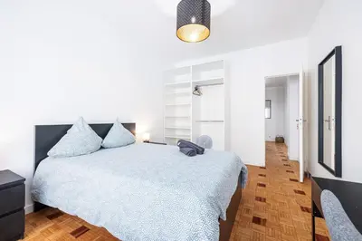 a white bedroom with a bed and a hallway at Chambre privée 1 personne BAIL MOBILITE in Nice