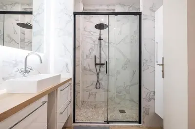 a shower with a glass door in a bathroom at Chambre privée 1 personne BAIL MOBILITE in Nice