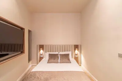 a bedroom with a bed with two pillows and a tv at 2BDR 6P central A C apt - heart of Nice - Beach in Nice