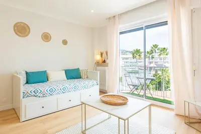 a living room with a bed and a large window at Nice - SweetHome Spacious Flat - Balcon in Nice