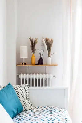 a white bedroom with a bed with blue pillows at Nice - SweetHome Spacious Flat - Balcon in Nice