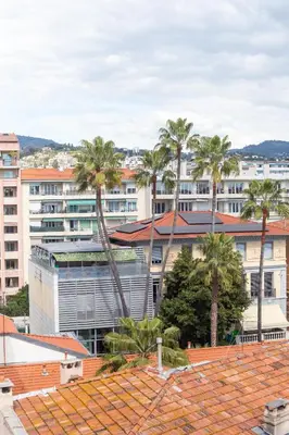 a view of a building with palm trees and buildings at Nice - SweetHome Spacious Flat - Balcon in Nice