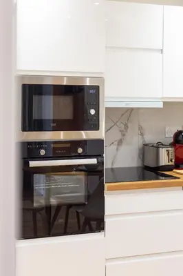 a kitchen with a microwave and a stove at Nice - SweetHome Spacious Flat - Balcon in Nice