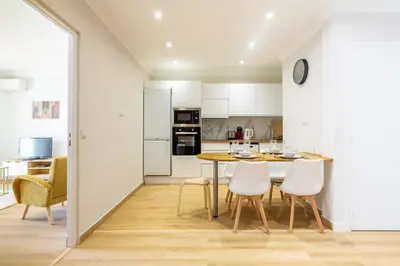 a kitchen and dining room with a table and chairs at Nice - SweetHome Spacious Flat - Balcon in Nice