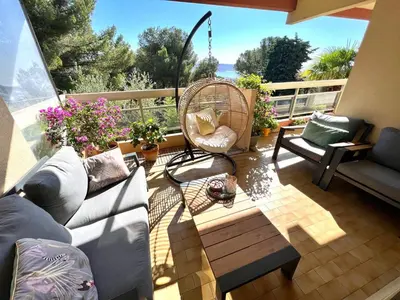 a patio with a couch and a chair and a table at La Vigie in Nice
