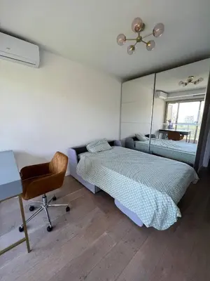 a bedroom with a bed and a desk and a mirror at La Vigie in Nice