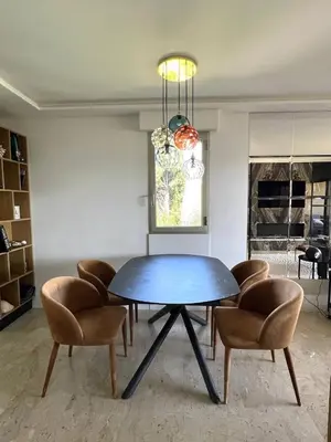 a dining room with a blue table and chairs at La Vigie in Nice