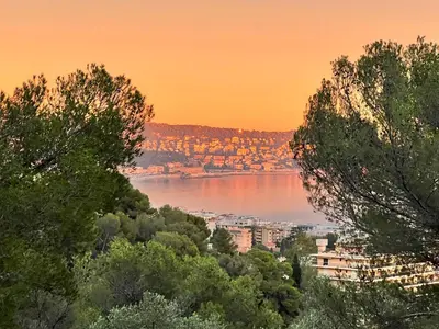 a view of a body of water at sunset at La Vigie in Nice