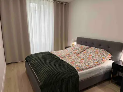 a bedroom with a bed with a blanket on it at Nikaia Residence - 2BR Central Nice Close to Everything in Nice