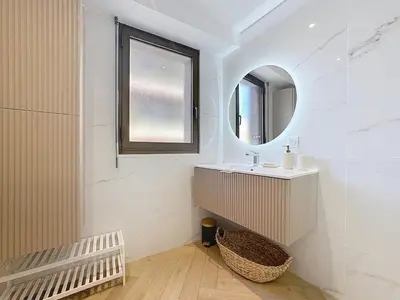 a bathroom with a sink and a mirror at Appartement chic avec balcon Carré d Or Nice in Nice