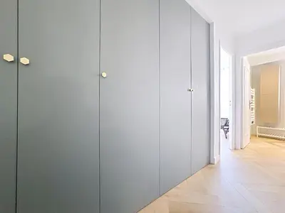 a room with gray cabinets and a hallway at Appartement chic avec balcon Carré d Or Nice in Nice