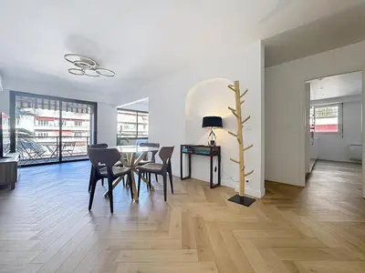 a living room with a dining room table and chairs at Appartement chic avec balcon Carré d Or Nice in Nice