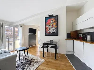 a living room with a table and a kitchen at Calm & Cozy Cocoon Place Masséna Downtown in Nice