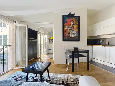 a living room with a table and a kitchen at Calm & Cozy Cocoon Place Masséna Downtown in Nice
