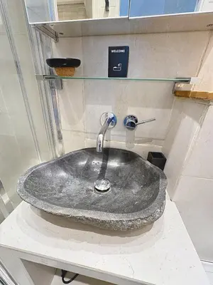 a bathroom sink with a stone counter top at Calm & Cozy Cocoon Place Masséna Downtown in Nice