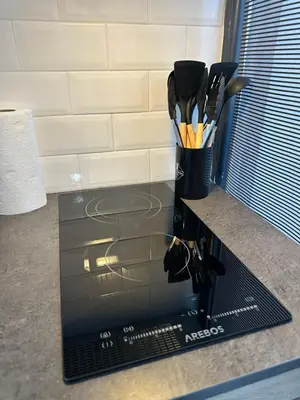 a container of utensils is sitting on a counter at Studio Azur in Nice