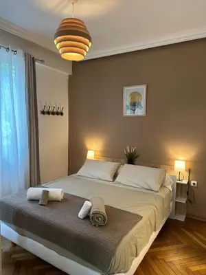 a bedroom with a large bed with two towels on it at A Sweet Escape for Two in Nice