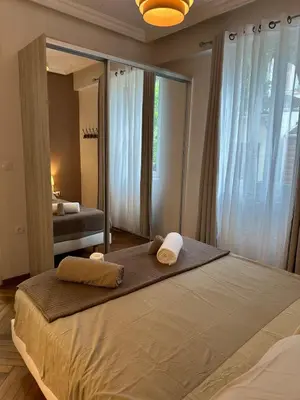a bedroom with a large bed with towels on it at A Sweet Escape for Two in Nice