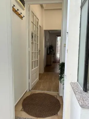 a hallway with a door and a rug at A Sweet Escape for Two in Nice