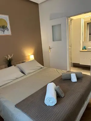 a bedroom with a large bed with towels on it at A Sweet Escape for Two in Nice