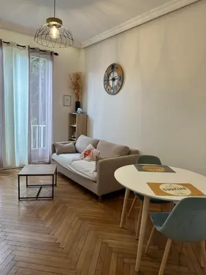 a living room with a couch and a table at A Sweet Escape for Two in Nice