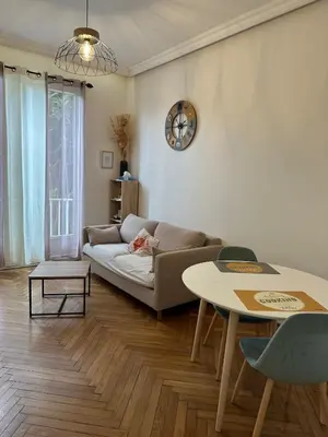 a living room with a couch and a table at A Sweet Escape for Two in Nice
