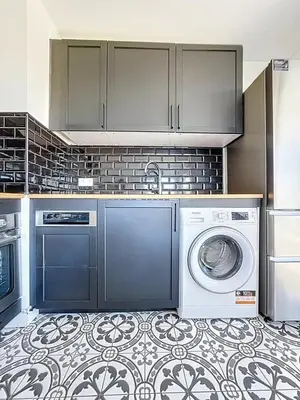 a kitchen with a washing machine and a washer at Comfort and relaxation and swimming pool in Nice