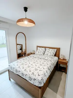 a bedroom with a bed and a mirror at Aya - Renovated air-conditioned duplex with garden in Nice