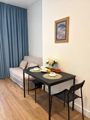 a living room with a table and a couch at BLUE SKY Apartment in Nice