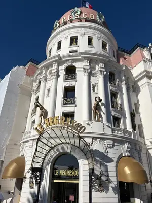 a tall white building with a sign on it at BLUE SKY Apartment in Nice