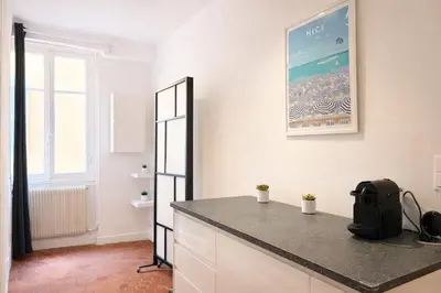 a kitchen with a counter top and a mirror at Charme du Vieux-Nice - cocon lumineux à 100 m de la mer in Nice