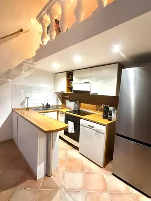 a kitchen with a counter top and a refrigerator at Vieux Nice bord de mer in Nice