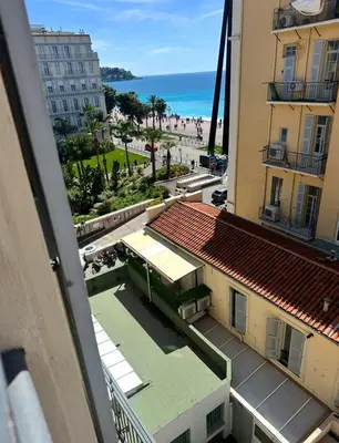a view of the beach from the balcony of a building at Vieux Nice bord de mer in Nice