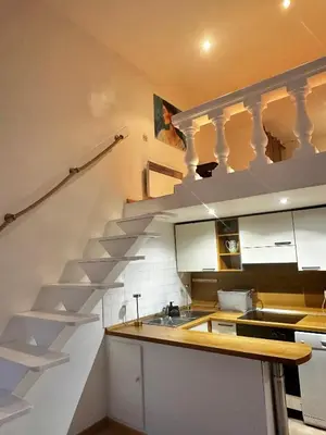 a kitchen with a staircase with a sink and a counter at Vieux Nice bord de mer in Nice