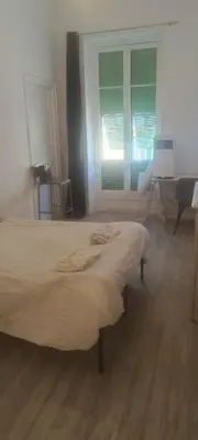 a bed in a room with a window and a desk at plein centre Nice magnifique chambre double climatisée in Nice