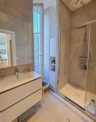 a bathroom with a shower and a sink and a glass shower at Bright Artist's Apartment On Nice Hills in Nice
