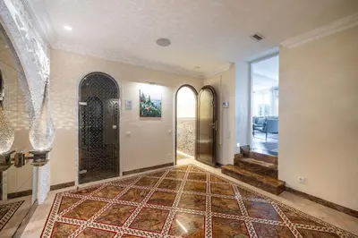 an empty hallway with a door and a tile floor at Villa Belle Epoque, sea view, pool & hammam in Èze