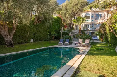 a swimming pool in the backyard of a house at Villa Belle Epoque, sea view, pool & hammam in Èze