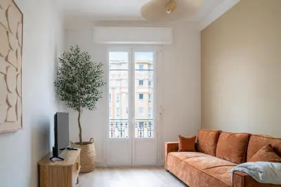 a living room with a couch and a window at Elegant apartment - Haut Musiciens in Nice