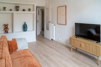 a living room with a couch and a flat screen tv at Elegant apartment - Haut Musiciens in Nice