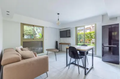 a living room with a couch and a table at Cagnes sur mer, 1 bedroom with Garden-Air conditioning-Wifi in Cagnes-sur-Mer