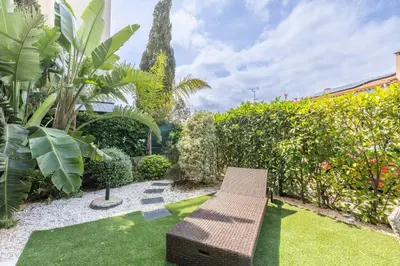 a bench in a garden with plants and trees at Cagnes sur mer, 1 bedroom with Garden-Air conditioning-Wifi in Cagnes-sur-Mer