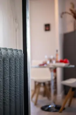 a view of a room with a table and a radiator at BelAzur - L'art de vivre au cœur de Nice in Nice