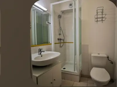 a bathroom with a sink and a toilet and a shower at Palais Des Domes Adagio Aparthotel in Nice