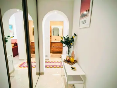 a room with a hallway with a table and a mirror at Modern Gem 200m from Beaches with Balcony, AC and Tram in Nice
