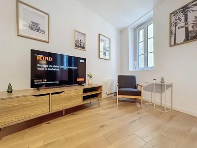 a living room with a large flat screen tv at Séjour idéal au cœur du Vieux-Nice in Nice