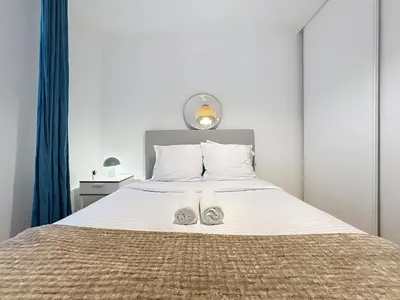 a bedroom with a bed with two shoes on it at Séjour idéal au cœur du Vieux-Nice in Nice