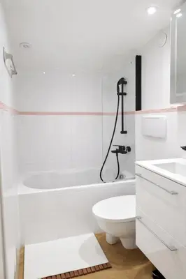 a white bathroom with a toilet and a sink at Azur Carré d'or Duplex 6 pers 2 min de la mer in Nice